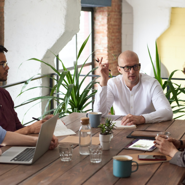 Bald man discussing ideas in a modern office meeting